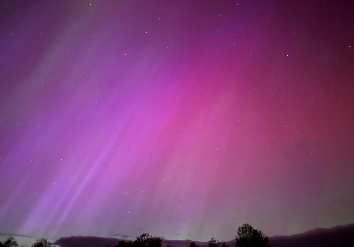 A purple sky with some light rays coming from it